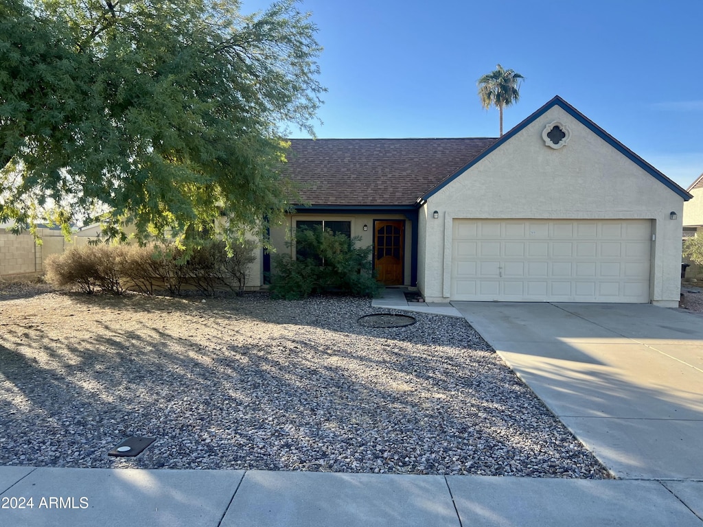 single story home featuring a garage