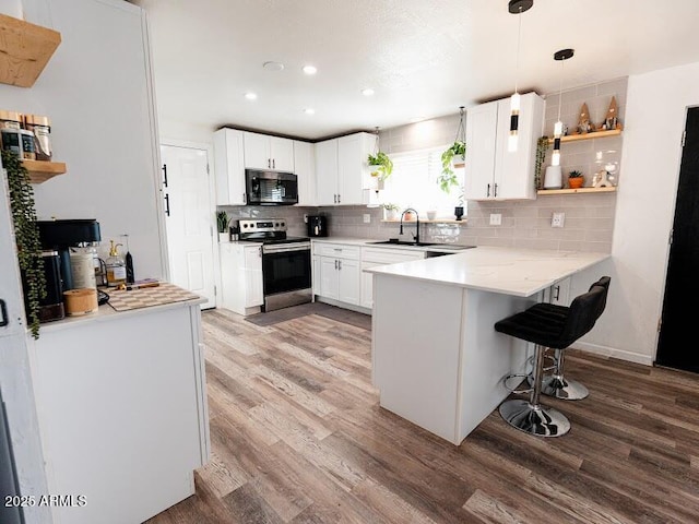 1705 S Cedar Dr, Apache Junction, AZ 85120 - kitchen featuring electric stove, a peninsula, light wood finished floors, decorative backsplash, and recessed lighting
