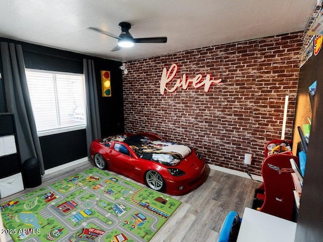 1705 S Cedar Dr, Apache Junction, AZ 85120 - bedroom with brick wall, wood finished floors, and a ceiling fan
