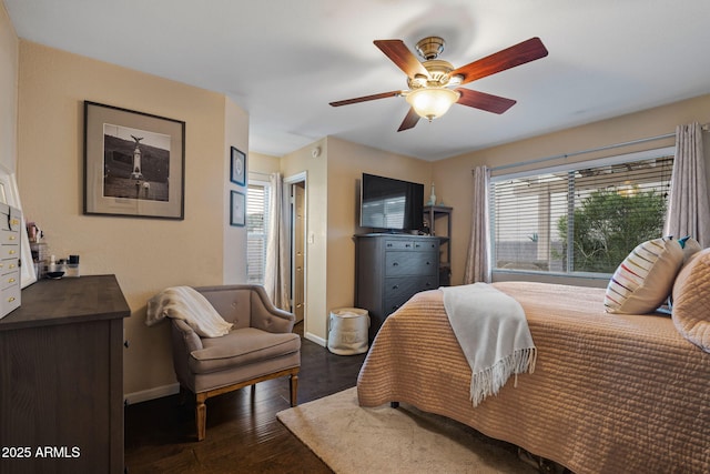 bedroom with dark hardwood / wood-style floors and ceiling fan