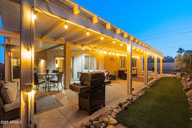 patio terrace at dusk with a grill and a pergola