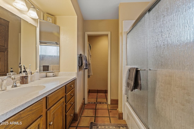 bathroom featuring vanity, tile patterned floors, and shower / bath combination with glass door