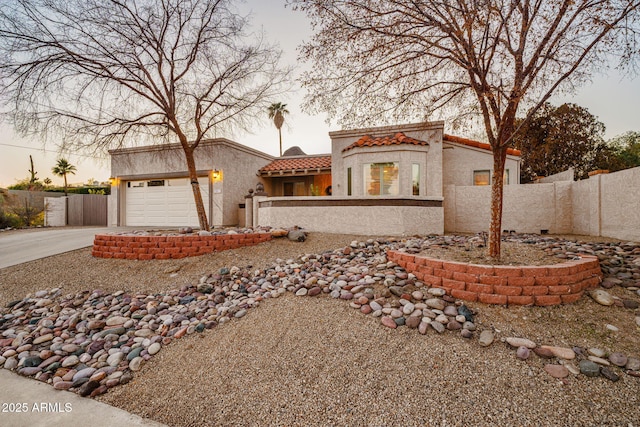 mediterranean / spanish-style house with a garage