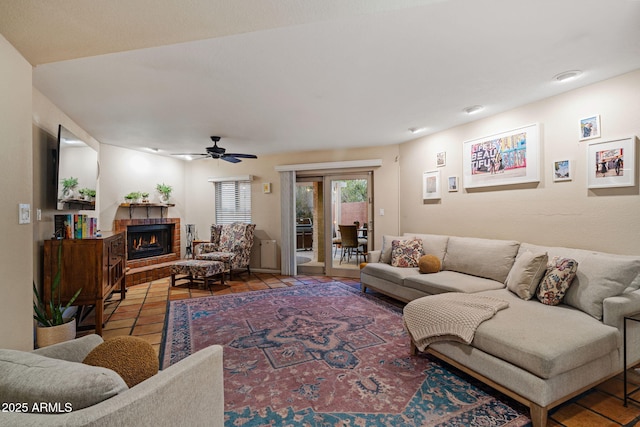 tiled living room featuring ceiling fan and a brick fireplace