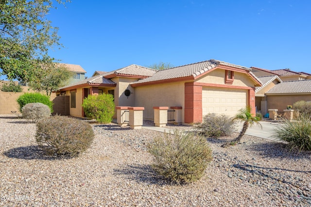 view of front of house with a garage, a tiled roof, and stucco siding