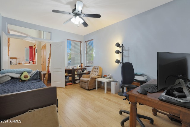 bedroom with light hardwood / wood-style floors and ceiling fan