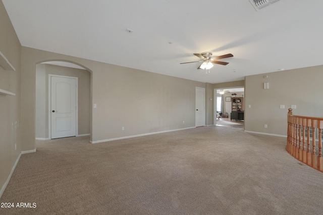 carpeted spare room featuring ceiling fan