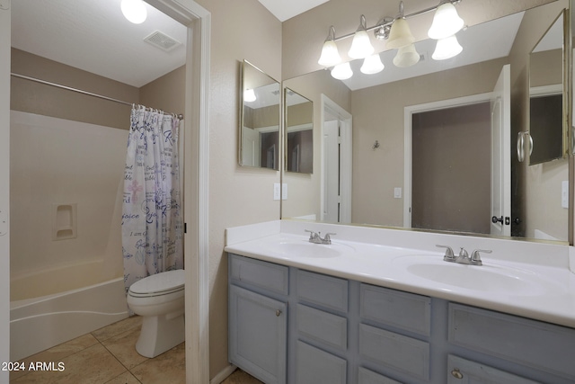 full bathroom with toilet, shower / tub combo with curtain, vanity, and tile patterned floors