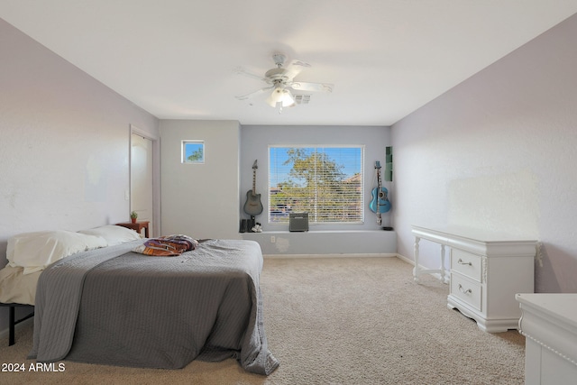 bedroom featuring light colored carpet and ceiling fan