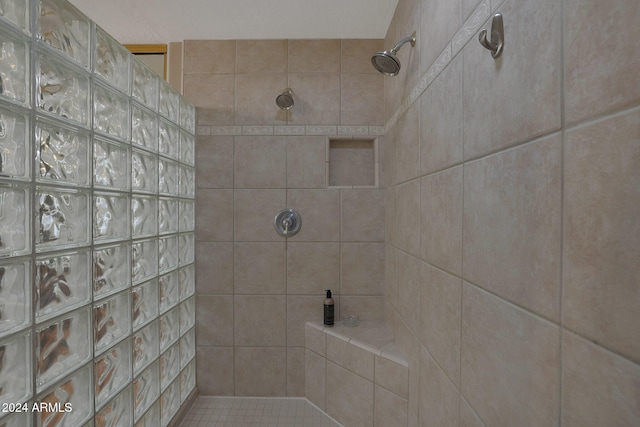 bathroom with a tile shower