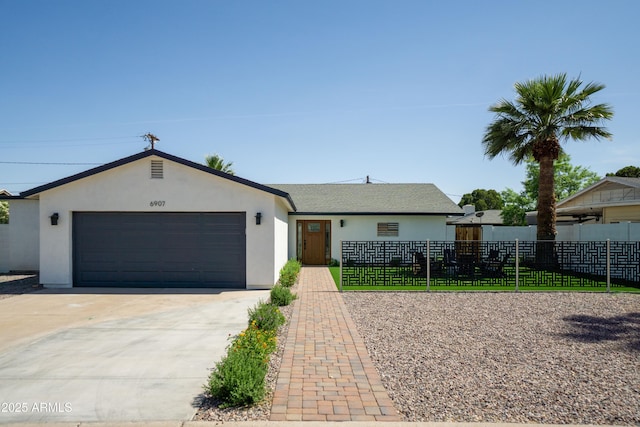 6907 E Palm Ln, Scottsdale, AZ 85257 - ranch-style house with stucco siding, driveway, and an attached garage