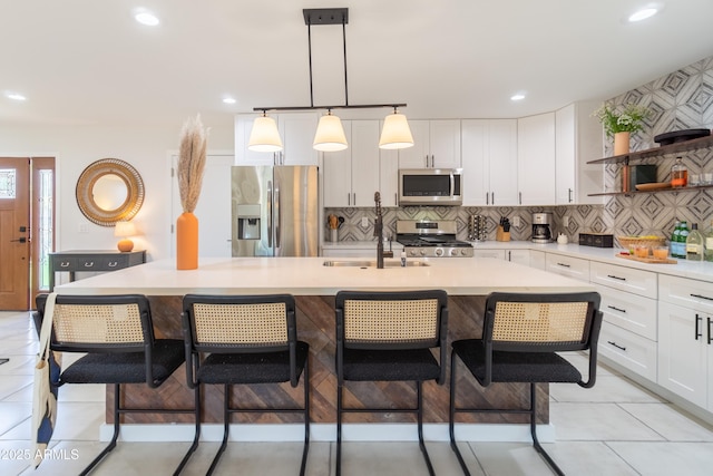 6907 E Palm Ln, Scottsdale, AZ 85257 - kitchen featuring appliances with stainless steel finishes, open shelves, light countertops, white cabinetry, and recessed lighting