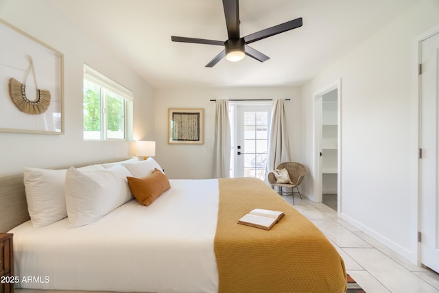 6907 E Palm Ln, Scottsdale, AZ 85257 - bedroom with access to outside, light tile patterned floors, a spacious closet, and a ceiling fan