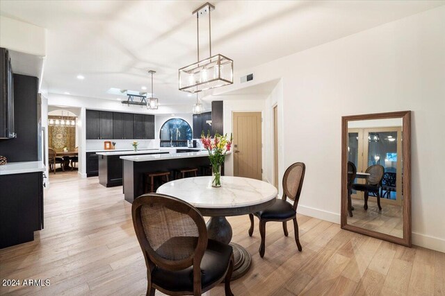 dining area featuring light wood-type flooring