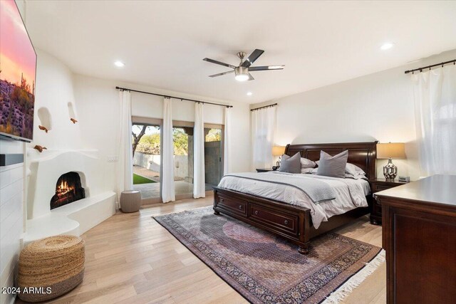 bedroom with ceiling fan, light hardwood / wood-style floors, and access to exterior