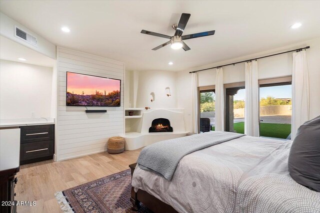 bedroom with ceiling fan, light wood-type flooring, and access to outside