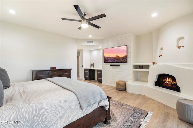 bedroom with ceiling fan and light hardwood / wood-style floors