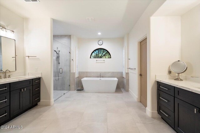 bathroom with tile patterned flooring, plus walk in shower, and vanity