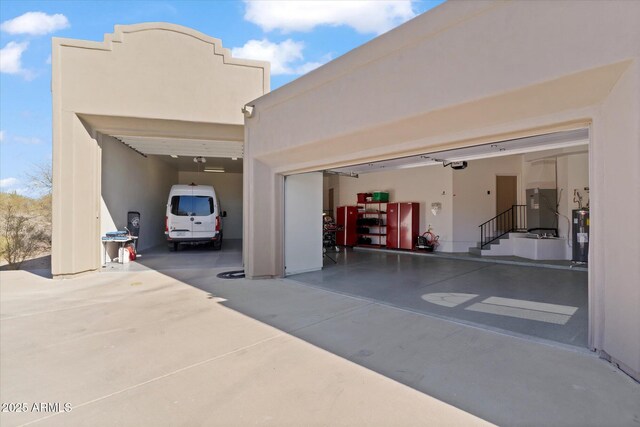 garage featuring a garage door opener and electric water heater