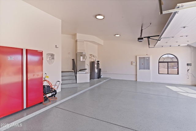 garage featuring a garage door opener, water heater, and heating unit