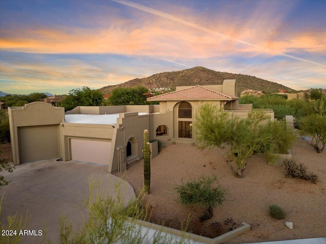 view of front of house featuring a garage and a mountain view