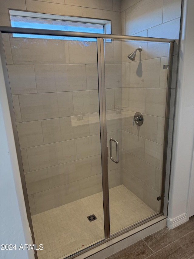 bathroom featuring a healthy amount of sunlight and an enclosed shower