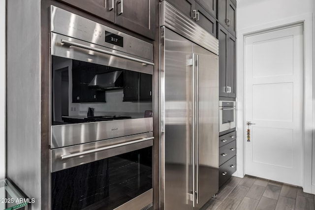 kitchen featuring appliances with stainless steel finishes and dark brown cabinets