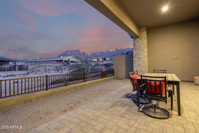 view of patio with outdoor dining space and a mountain view