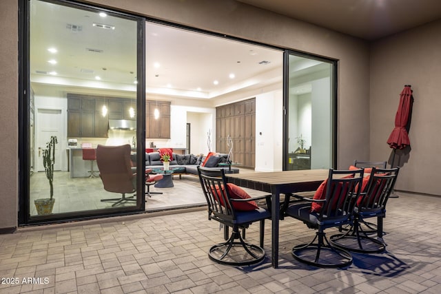 dining room with brick floor and recessed lighting