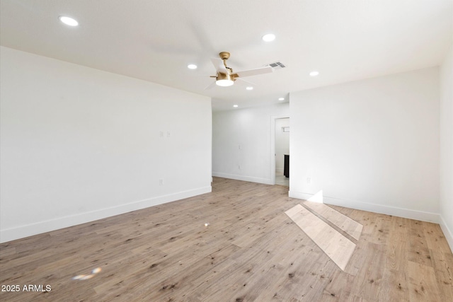 spare room with ceiling fan and light wood-type flooring