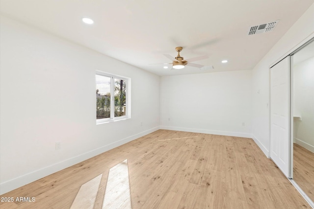 unfurnished bedroom with light hardwood / wood-style flooring, a closet, and ceiling fan