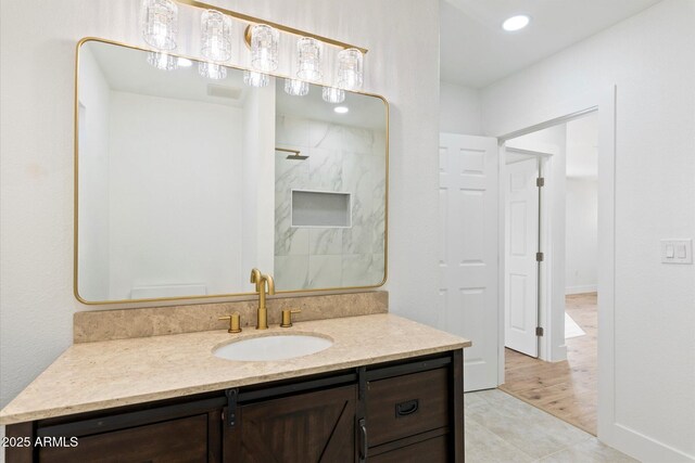 bathroom with vanity and a shower