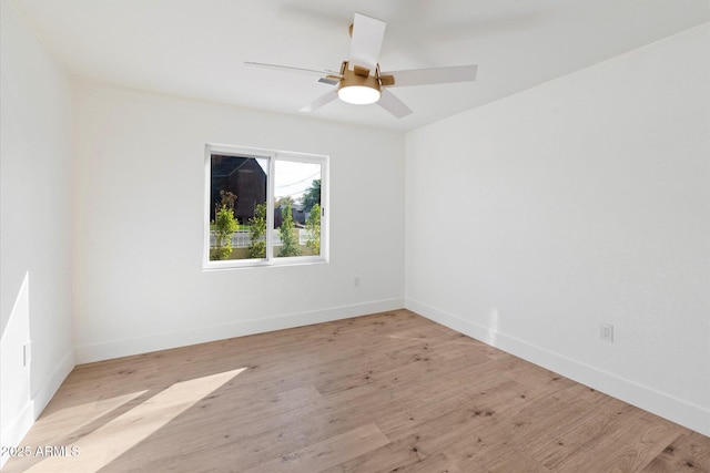 spare room featuring ceiling fan and light wood-type flooring