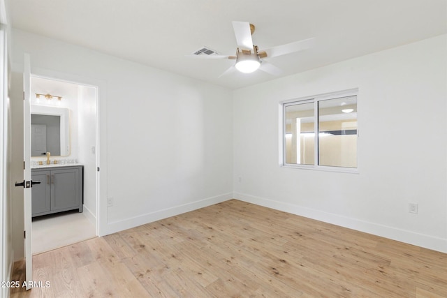 spare room with sink, light hardwood / wood-style flooring, and ceiling fan