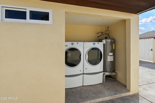 laundry room featuring water heater and independent washer and dryer