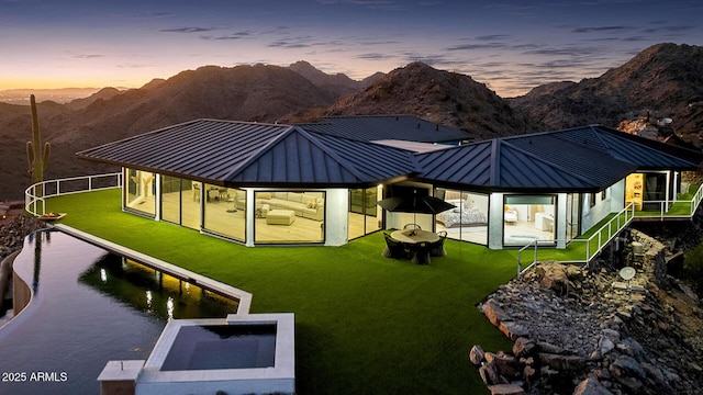 back house at dusk featuring a gazebo and a mountain view