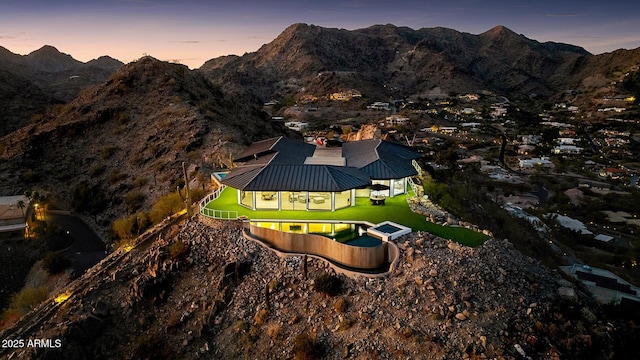 aerial view at dusk featuring a mountain view