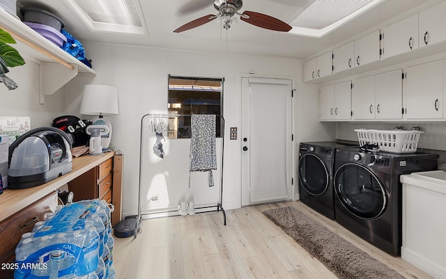 clothes washing area featuring cabinets, independent washer and dryer, ceiling fan, and light hardwood / wood-style floors