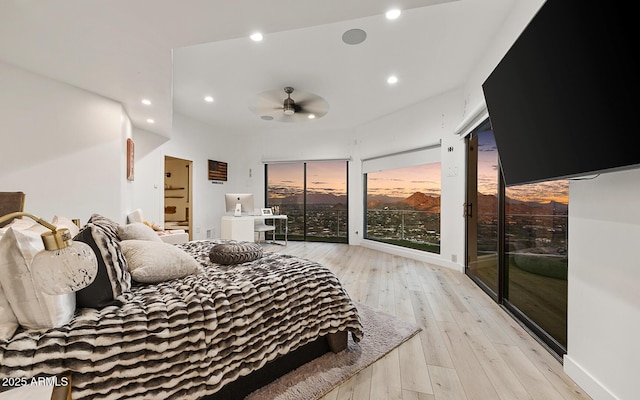 bedroom with access to exterior and light hardwood / wood-style floors