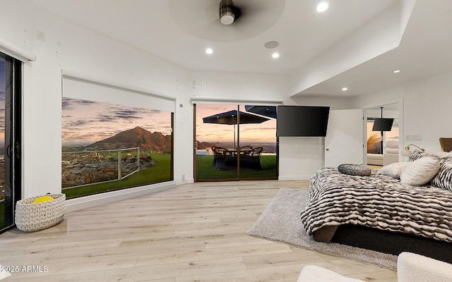 bedroom with ceiling fan, access to outside, and light wood-type flooring