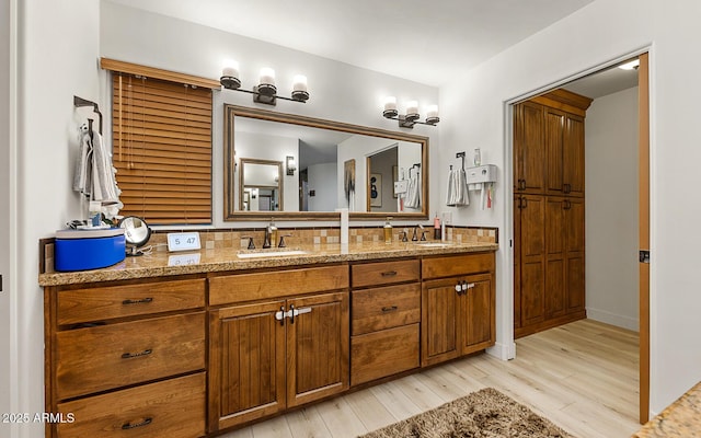 bathroom with wood-type flooring, vanity, and backsplash