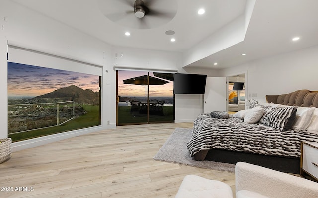 bedroom with light hardwood / wood-style flooring and ceiling fan