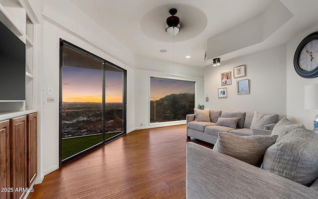 living room featuring hardwood / wood-style flooring and ceiling fan