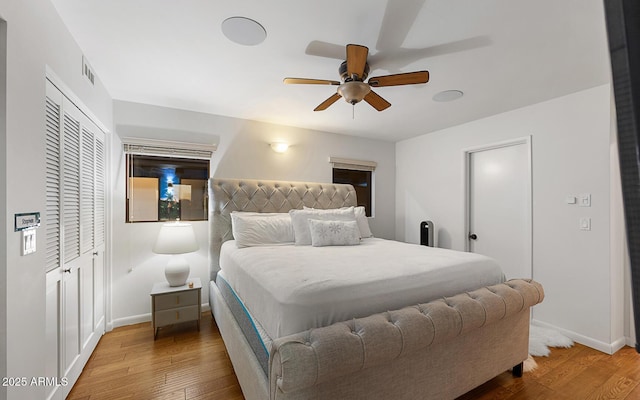 bedroom with wood-type flooring, a closet, and ceiling fan