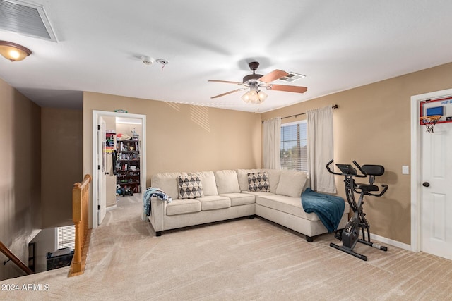 living room with baseboards, a ceiling fan, visible vents, and light colored carpet