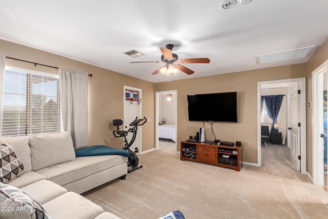 carpeted living room with baseboards, visible vents, and ceiling fan