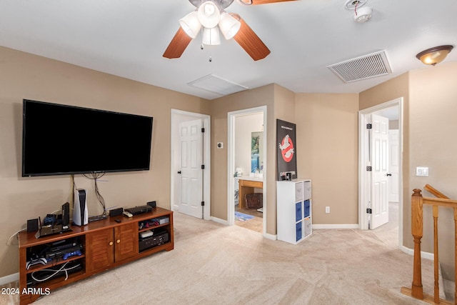 living area with light carpet, visible vents, and baseboards