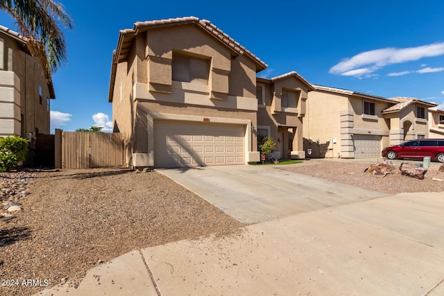 view of front of property with a garage, a tiled roof, concrete driveway, and stucco siding