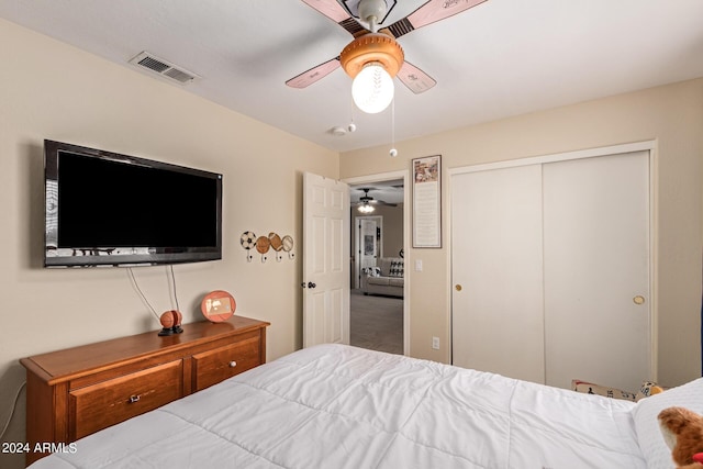 bedroom with ceiling fan, visible vents, and a closet