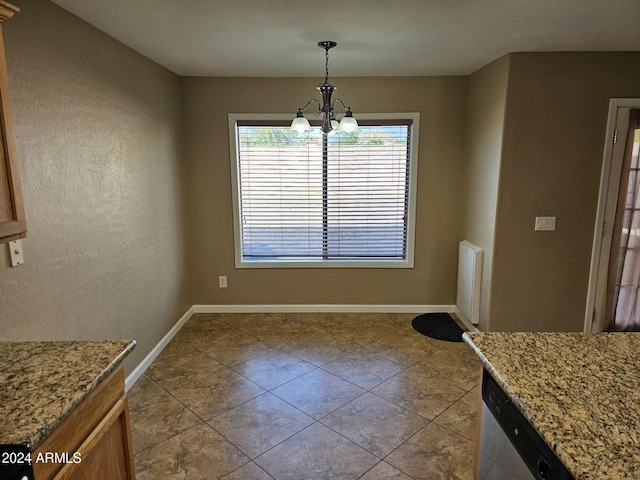 unfurnished dining area with tile patterned flooring, a notable chandelier, and baseboards